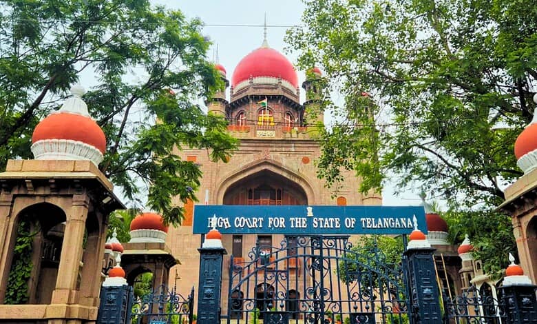 High Court for the State of Telangana building with trees and gate in front.