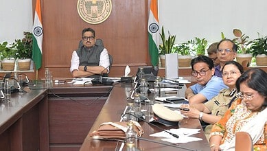Officials and officials seated at a conference table during a formal meeting in Telangana.