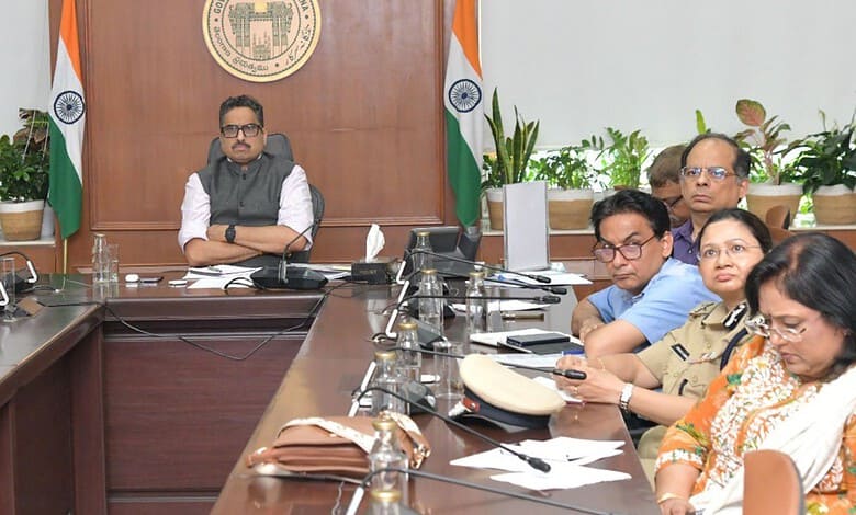 Officials and officials seated at a conference table during a formal meeting in Telangana.