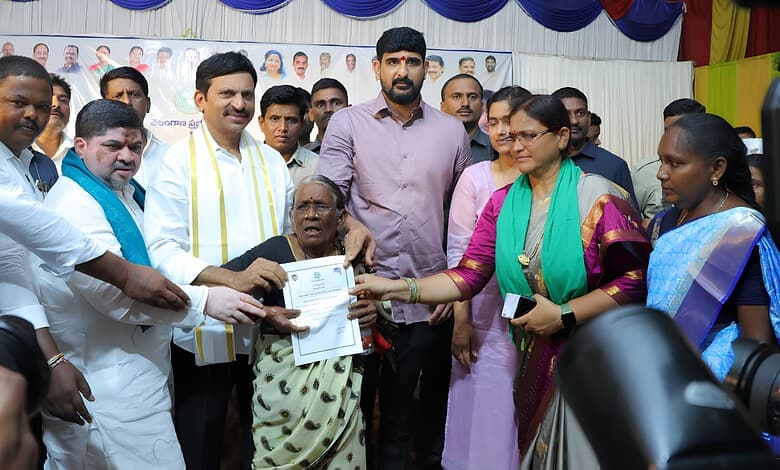 Telangana government officials hand over Indiramma house documents to beneficiaries in Hanumakonda.