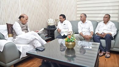 Telangana officials meet with senior leader in a formal office setting.