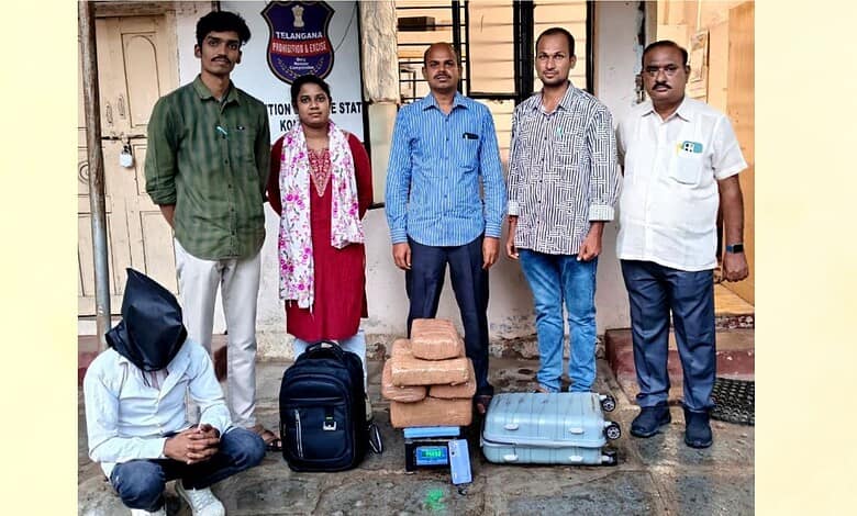 Police officers and a suspect with seized 14 kg ganja in front of a police station.