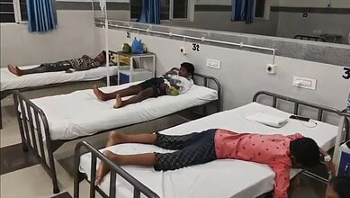 Three students lying on hospital beds after food poisoning incident in Mancherial.