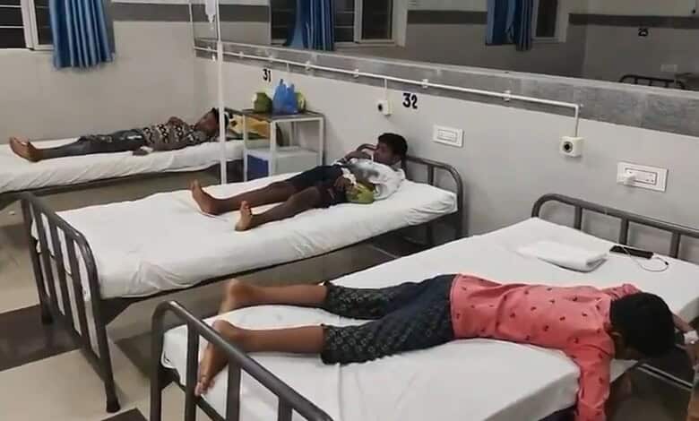 Three students lying on hospital beds after food poisoning incident in Mancherial.