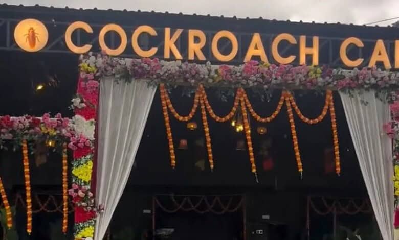 Cockroach Cafe sign with floral decorations in Bihar, India.