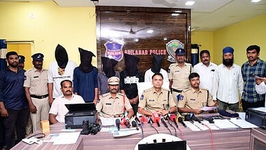 Police officials and suspects involved in forging documents and fake IDs at a press conference.