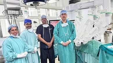 Medical team performing robotic surgery in a modern operating room.