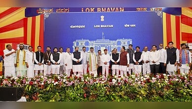 Group of Karnataka ministers and officials on stage during cabinet induction ceremony.