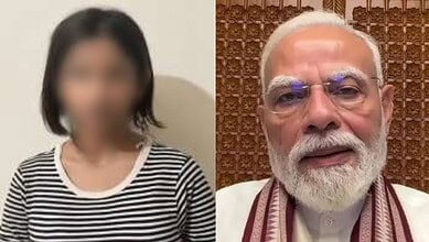 Indian Prime Minister Narendra Modi with a woman in a striped shirt.