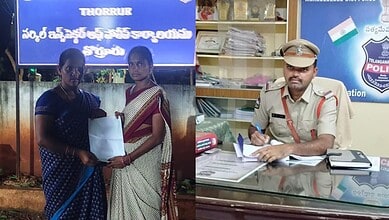Police officer at a desk with two women in traditional attire in an office setting.
