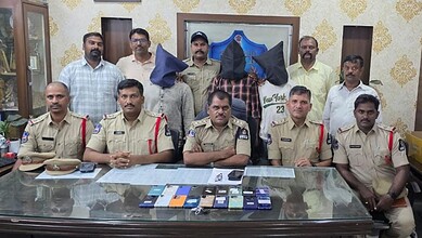 Hyderabad police display seized mobile phones and arrest suspects in a press conference.