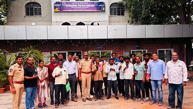 Group of police officers and civilians outside Afzalgunj Police Station in Hyderabad.