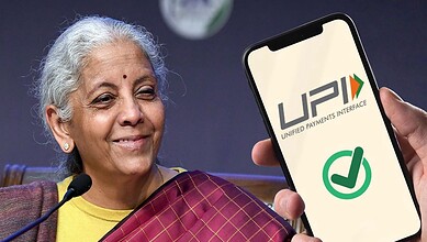 Indian woman holding a smartphone displaying UPI logo during a press conference.