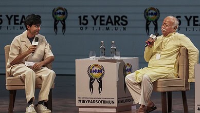Prime Minister Narendra Modi and a young speaker in discussion at the event.