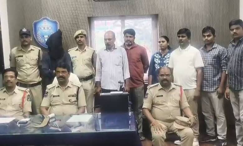 Police officers and individuals in a room related to Saidabad murder case.