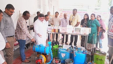 Officials inspect water pumping equipment at a public event in Hyderabad.