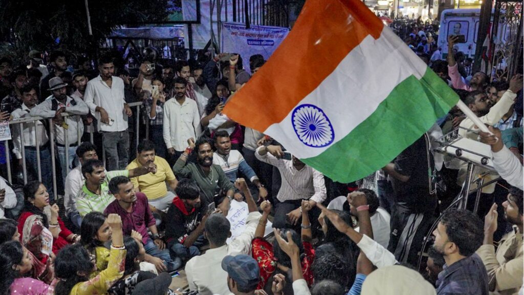 Protesters gather with Indian flag during paper leak protests in Jharkhand.