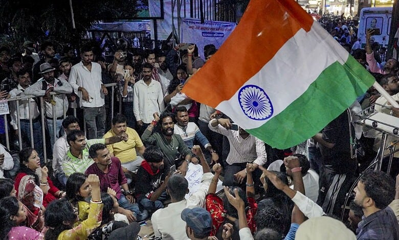 Protesters gather with Indian flag during paper leak protests in Jharkhand.