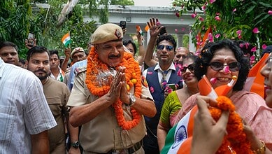 A Delhi police official is garlanded during the event