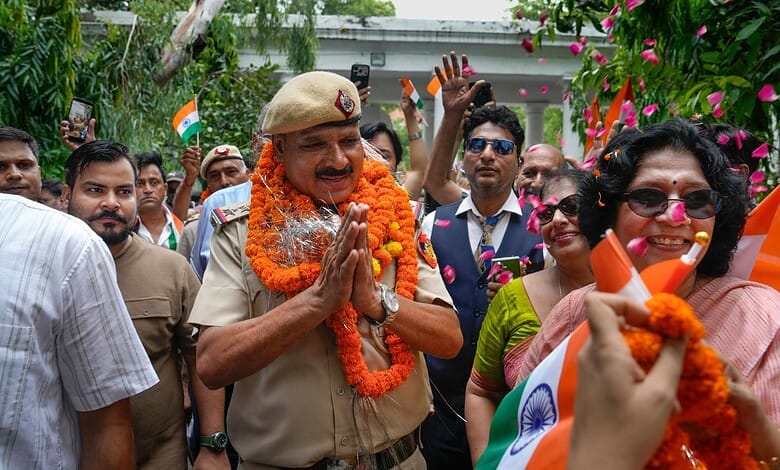 A Delhi police official is garlanded during the event