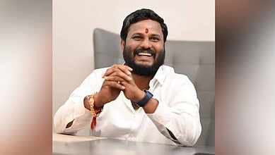 Telangana Congress leader Neelam Madhu Mudiraj smiling in an office setting.