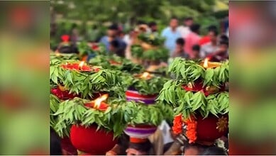 People participating in Bonalu festival with decorated pots on their heads in Hyderabad's Old City.