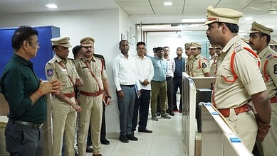 Hyderabad police officers and officials in a briefing room during cyber fraud investigation.