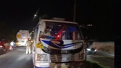 Overturned mini-bus with Tiranga flags after accident in Jammu at night.