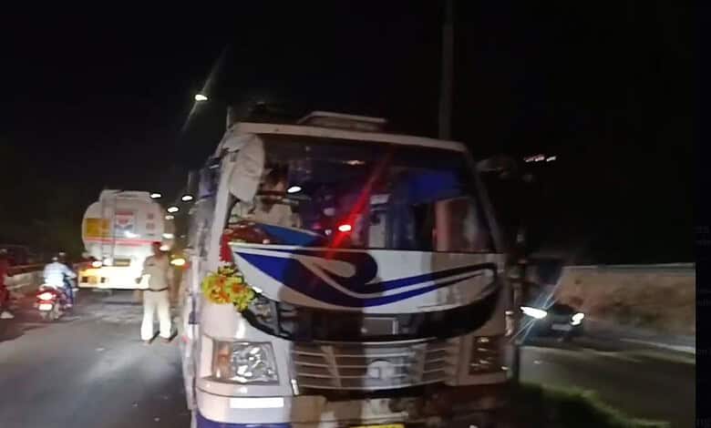 Overturned mini-bus with Tiranga flags after accident in Jammu at night.