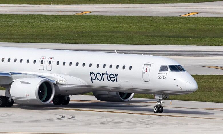 Porter Airlines aircraft on runway with green grass in background.