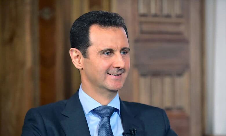 Syrian President Bashar al-Assad smiling during a formal event or interview.