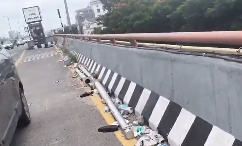 Litter and broken bottles scattered along PVNR Expressway in Hyderabad.