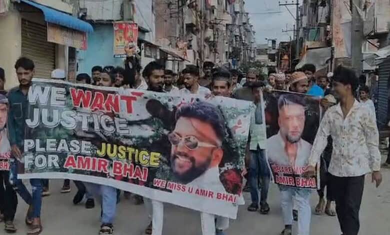 Protesters march in Saidabad demanding justice for Amir Bhai, with banners and photos of the slain auto r.