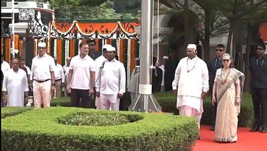 Political leaders and officials walking on a red carpet during a public event in India.