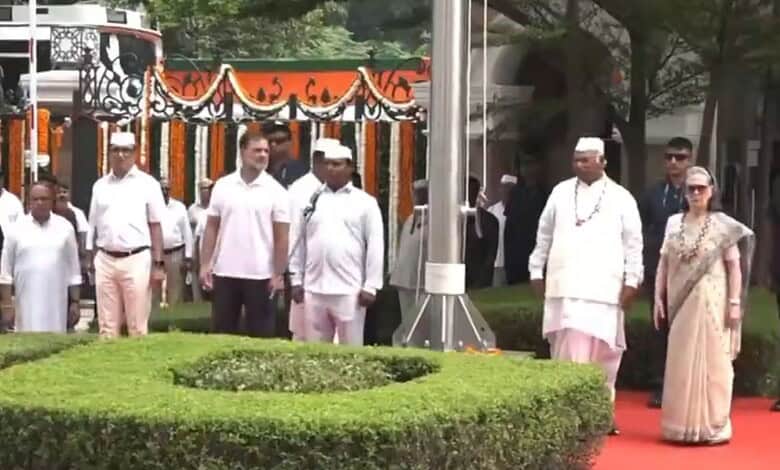 Political leaders and officials walking on a red carpet during a public event in India.