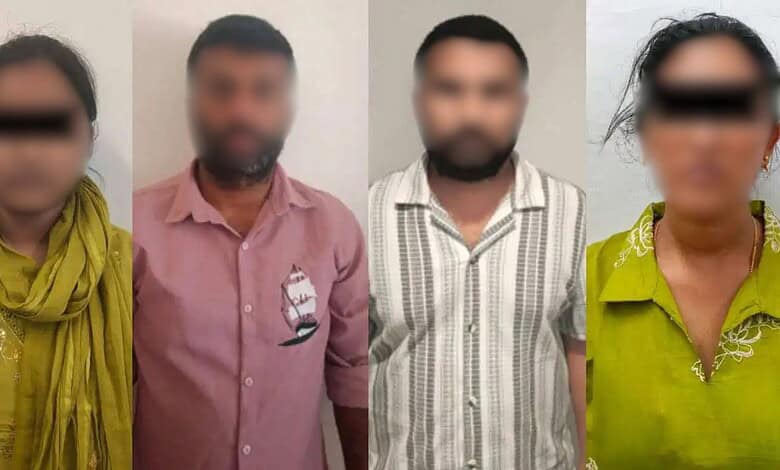 Four individuals with blurred faces standing indoors, three men and one woman, in casual attire.