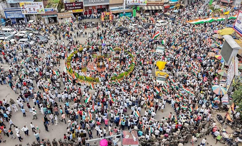 Large crowd gathered in a busy marketplace during Jharkhand exam stir protests.
