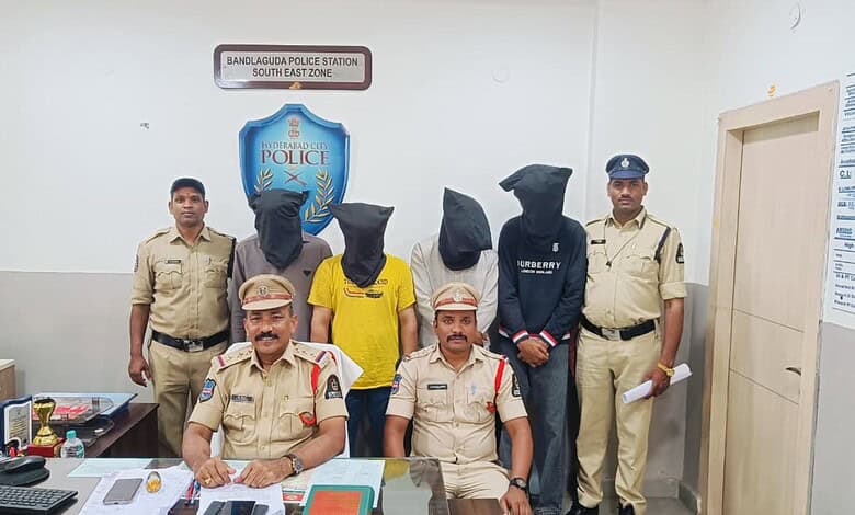 Police officers with detained suspects at Bandlaguda Police Station in Hyderabad.