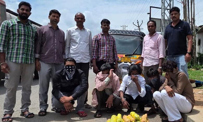 Group of men and women involved in drug bust with seized ganja in Telangana, India.