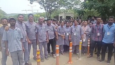 Staff members gather outside Visakhapatnam Airport during its closure.