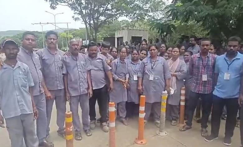 Staff members gather outside Visakhapatnam Airport during its closure.