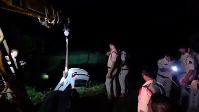 Police and rescue team at the scene of a car accident in Telangana's Siddipet at night.