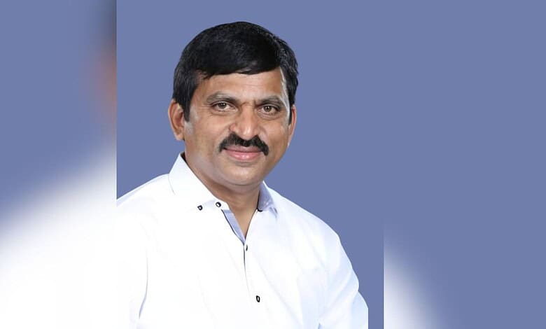 Ponguleti Srinivas Reddy, politician, in a white shirt, smiling against a blue background.
