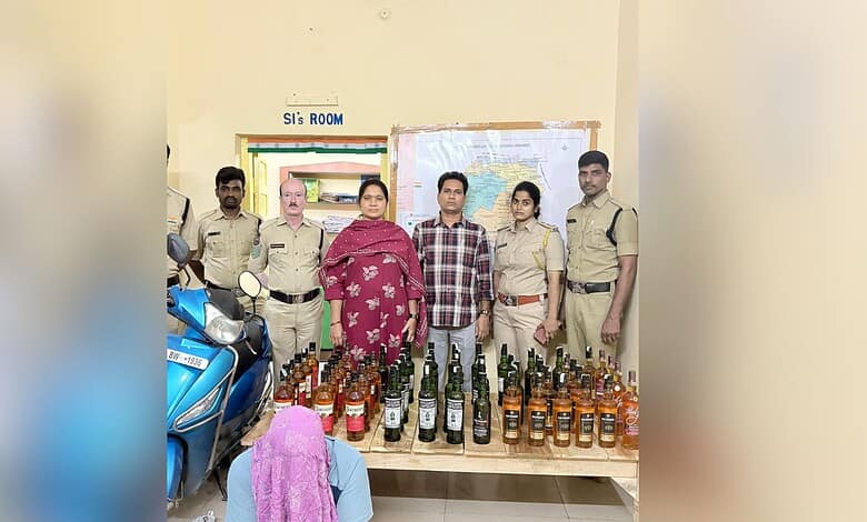 Telangana exise officials with the arrested man and seized liqour