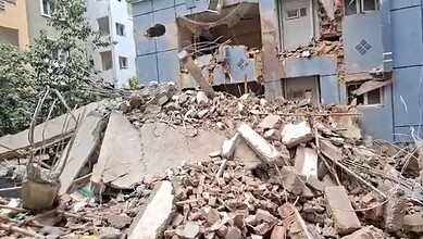 Building collapse with debris and damaged structure in an urban area.