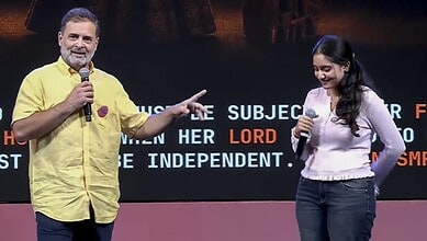 Rahul Gandhi and a woman speaking on stage during a public event.