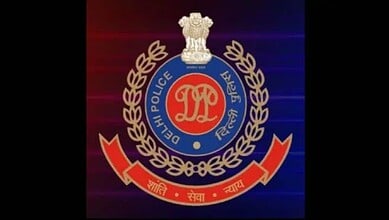 Delhi Police emblem with badge and laurel wreath on a dark background.