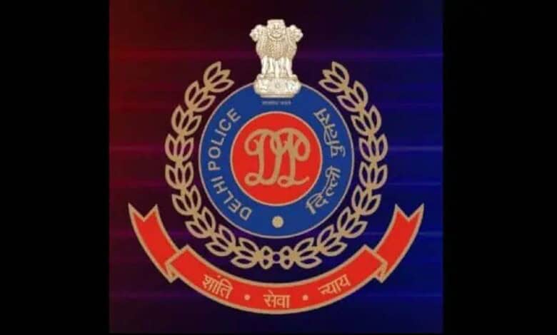 Delhi Police emblem with badge and laurel wreath on a dark background.