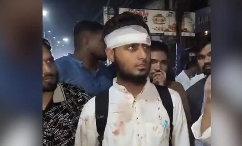 Madrassa student with a bandaged head surrounded by people in a crowded area.