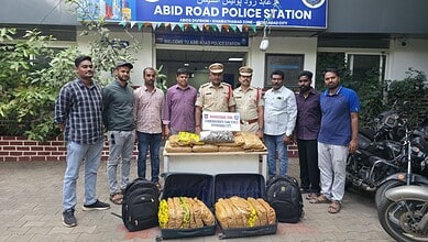 Police officers and suspects with seized dry ganja outside Abid Road Police Station in Hyderabad.